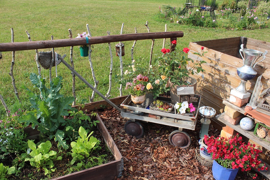 Ein kleiner Wagen voller Blumen und ein rustikaler Zaun aus Ästen: Daniela hat das richtige Gespür für die passende Deko. 