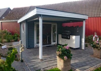 Gartenhaus mit Terrasse: So finden Sie das passende Haus für Ihren Garten Gartenhaus grau weiß mit überdachter Terrasse